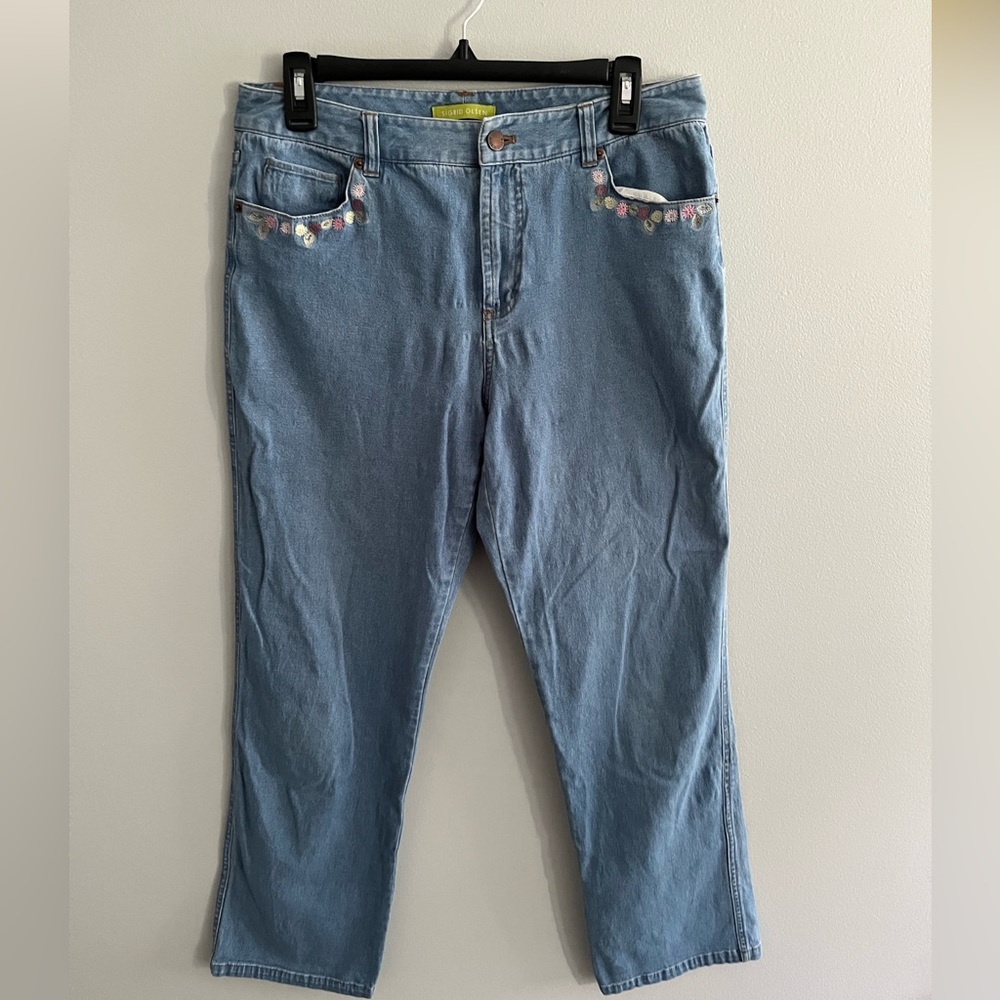 Size 8 straight leg jeans with floral decal on pockets.